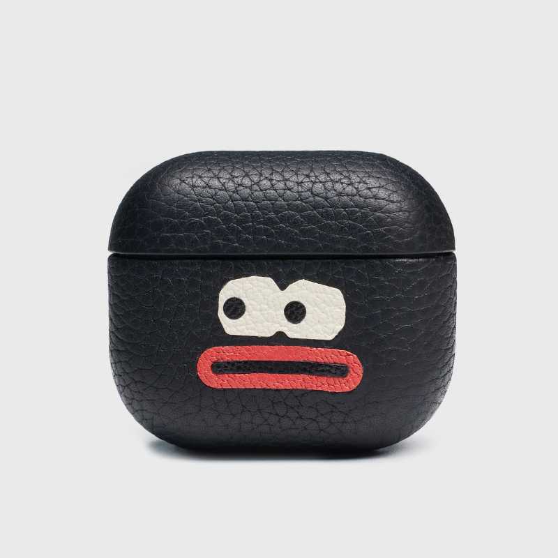 Handmade leather AirPods Pro 3 case made of lychee-grain cowhide Black leather airpod case with a cartoon face design on a light gray background