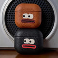 Cool Handmade Leather AirPods Pro 3 Case iWoodStor Two leather cases with cartoon face designs on a speaker background