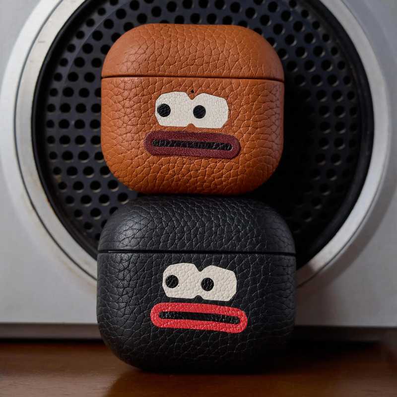 Cool Handmade Leather AirPods Pro 3 Case iWoodStor Two leather cases with cartoon face designs on a speaker background