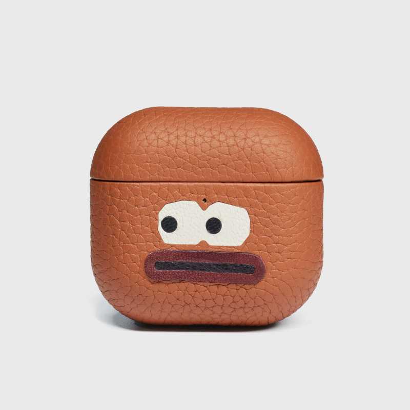 Top lid with nano adhesive for secure closure Brown textured airpod case with cartoon face design on a white background