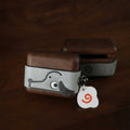 Cute Doggy AirPods Pro Case Wood Walnut Leather iwoodstore Small wooden box with a cartoon dog design and a tag on a dark background
