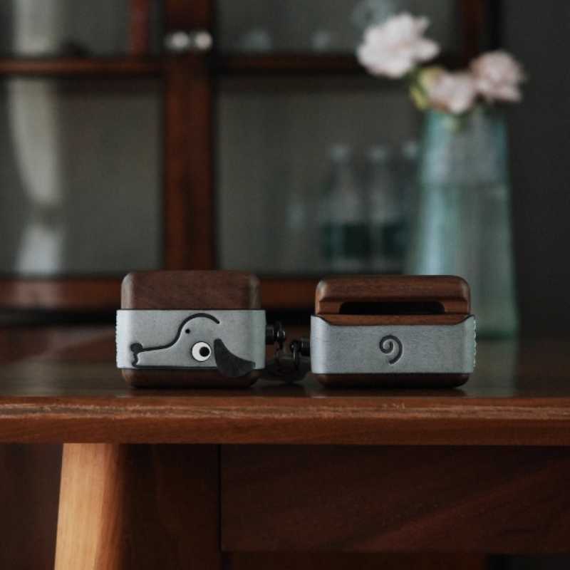 Cute Doggy AirPods Pro Case Wood Walnut Leather iwoodstore Two wooden and metal items on a wooden surface with a blurred background