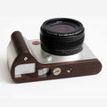 Camera with wooden casing and Leica logo on a white background