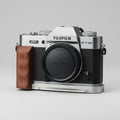 Fujifilm X-T30 camera with wooden grip on a light gray background