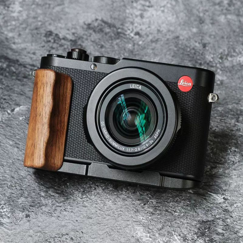 Leica camera with a wooden grip on a gray background