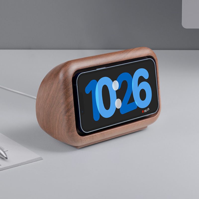 Digital clock with wooden casing on a gray surface