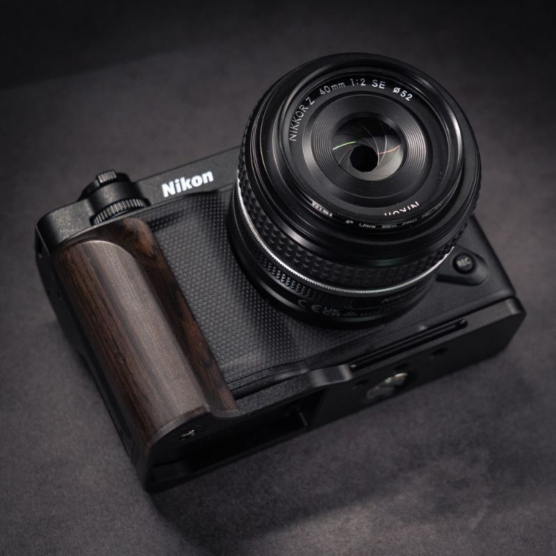 Nikon camera with wooden grip on a dark background