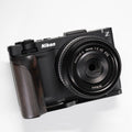 Black Nikon camera on a white background