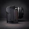 Camera with wooden grip on a dark background