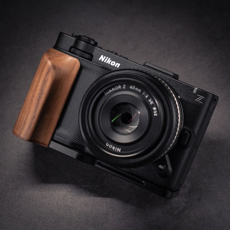 Nikon ZR camera with wooden grip on a white background