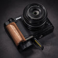 Nikon camera with wooden grip on a dark background