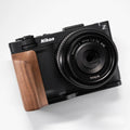 Nikon ZR camera with wooden grip on a white background