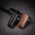 Black and wooden camera hand grips on a dark background