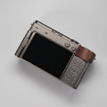 Camera with wooden grip on a dark wooden surface