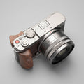 Camera with wooden grip on a dark textured surface