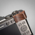 Close-up of a camera with wooden grip on a dark background