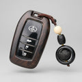 Toyota Wooden car key case with decorative pendant on a gray background