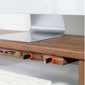 Wood Telescopic Retractable Data Cable Charging Cable For Desk iWoodStore Wooden desk with USB ports and a computer monitor on a light gray surface.