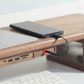 Wood Telescopic Retractable Data Cable Charging Cable For Desk iWoodStore Smartphone charging on a wooden desk with multiple USB ports.
