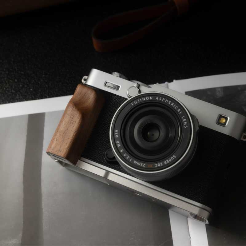 Camera with wooden grip on a dark background