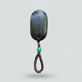 Decorative wall hook with a green bead on a gray background